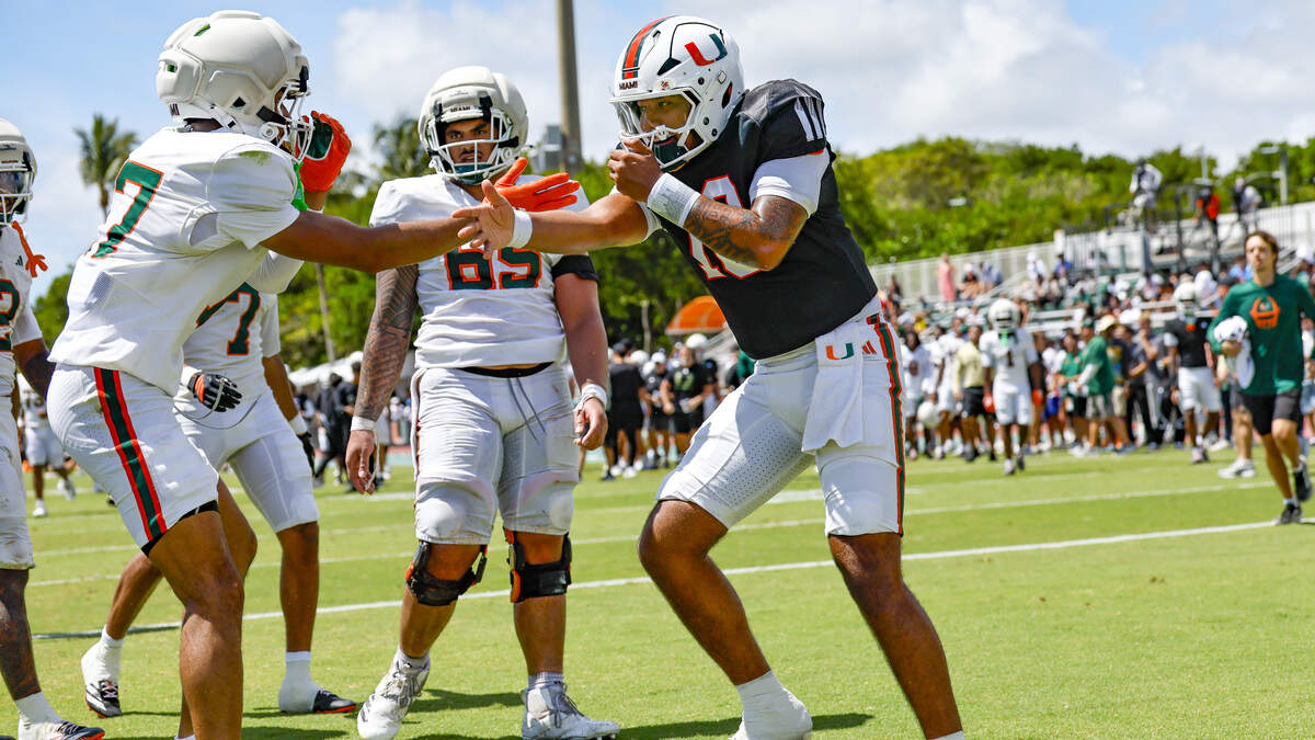 Miami Hurricanes quarterback Darian Mensah (10) and wide receiver Cam Vaughn (17) celebrate after Vaughn scores on a pass from Mensah during UM’s spring football game at Cobb Stadium on the University of Miami campus in Coral Gables, Florida, on Saturday, April 18, 2026. Miami Hurricanes quarterback Darian Mensah (10) and wide receiver Cam Vaughn (17) celebrate after Vaughn scores on a pass from Mensah during UM’s spring football game at Cobb Stadium on the University of Miami campus in Coral Gables, Florida, on Saturday, April 18, 2026.